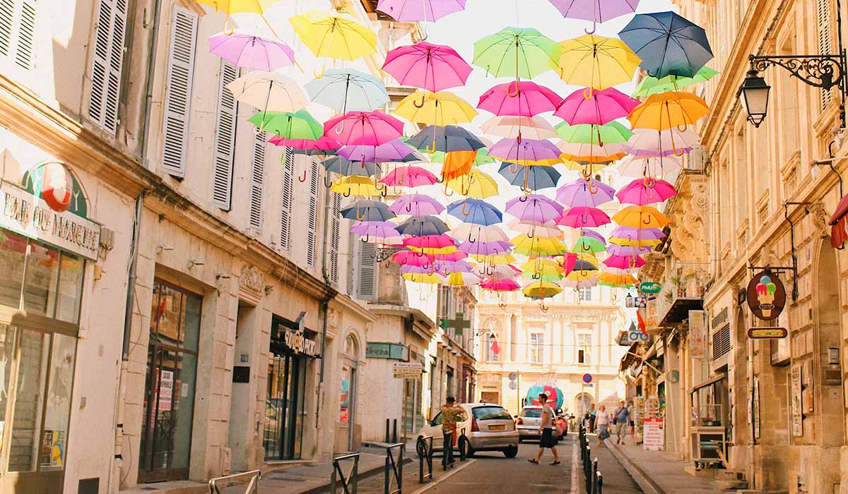 colorful umbrellas hanging over street in france